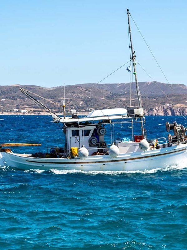 fishing-boat-moving-in-wavy-sea-cyclades-greece-resize.jpg